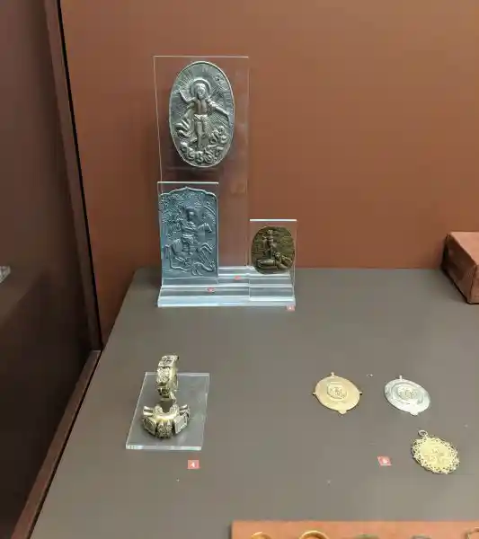 Collection of Byzantine miniature icons showing Resurrection and Saint George with decorative Christian pendants